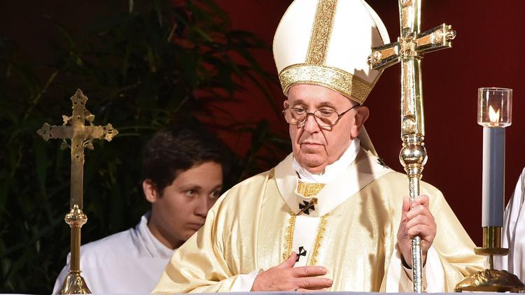 Pope Francis celebrates a Mass on Sunday for All Saints' Day at Campo di Verano cemetery in Rome. The Holy See revealed the following day that two people had been arrested in a probe of leaked Vatican confidential documents. (Alberto Pizzoli / AFP/Getty Images)