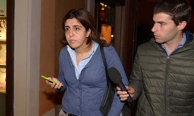 Francesca Chaouqui, who was a member of a special commission set up by Pope Francis to advise him on economic reform within the Vatican, walks while flanked by a journalist in Rome on Tuesday. Photograph: Vincenzo Pinto/AFP/Getty Images