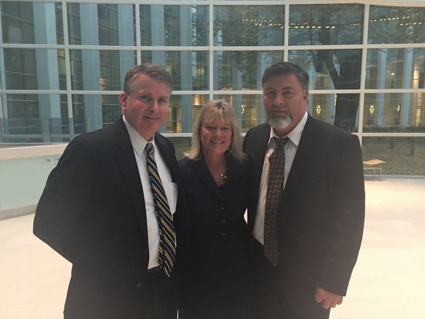 Childhood sex abuse survivor Kathy Picard is shown here with lawyer John B. Stewart, left, and her husband, right, after a jury awarded her $250,000 after a civil trial in which she sued her stepfather for molesting her. (Stephanie Barry / The Republican)