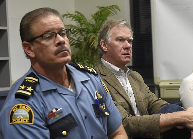 St. Paul Police Chief Tom Smith and St. Paul Mayor Chris Coleman listen to a question during a crowded community meeting at the St. Paul Police Department Eastern District precinct Wednesday, October 21, 2015. (Pioneer Press: John Autey)