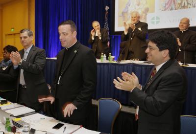 Msgr. Brian Bransfield, associate general secretary of the U.S. Conference of Catholic Bishops, front center, is applauded Nov. 17 after being elected general secretary of the USCCB during the bishops' 2015 fall general assembly in Baltimore. (CNS photo/Bob Roller)