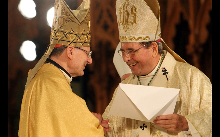 Archbishop John J. Myers of Newark, N.J. (right), smiles as he receives an apostolic letter from Cardinal Angelo Amato during the beatification Mass for Blessed Miriam Teresa Demjanovich in Newark, Oct. 4, 2014. (CNS/