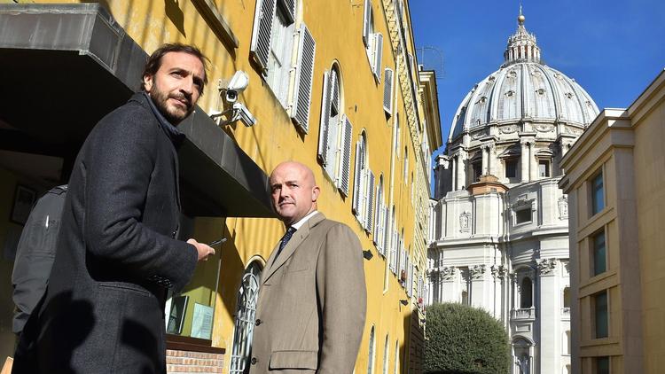 Italian journalists-writers Gianluigi Nuzzi, right, and Emiliano Fittipaldi arrive for the first day of their trial at the Vatican on Tuesday. The Vatican has placed the two Italian journalists under investigation in its probe over leaked documents that revealed waste, greed and mismanagement at the highest levels of the Roman Catholic Church. (Ettore Ferrari / European Pressphoto Agency)