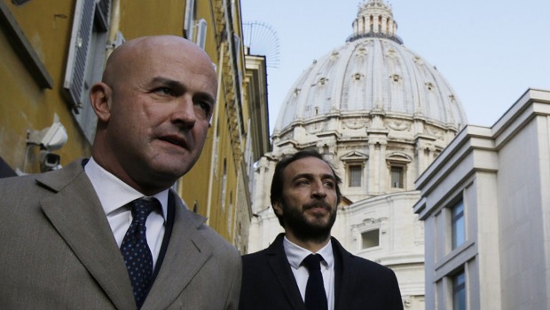 Italian journalists Gianluigi Nuzzi, left, and Emiliano Fittipaldi, have outlined divisions between Cardinal Pell and the Pope. Photo: AP
