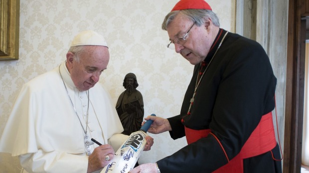 Perhaps it should have been a broom. Pope Francis signs a cricket bat he received from Cardinal George Pell at the Vatican. Photo: AP