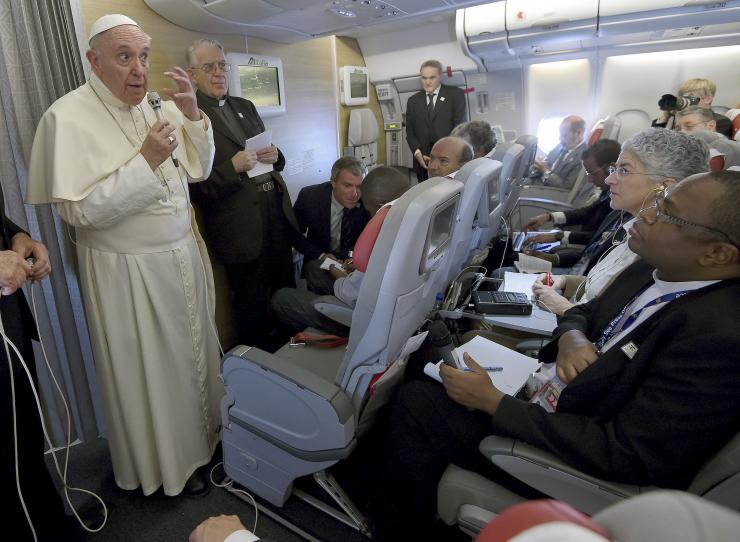 Pope Francis gestures during a meeting with the media on board the papal plane while en route to Rome, Nov. 30, 2015. The pope has ordered an audit of the church's finances. Reuters/Daniel Dal Zennaro/pool