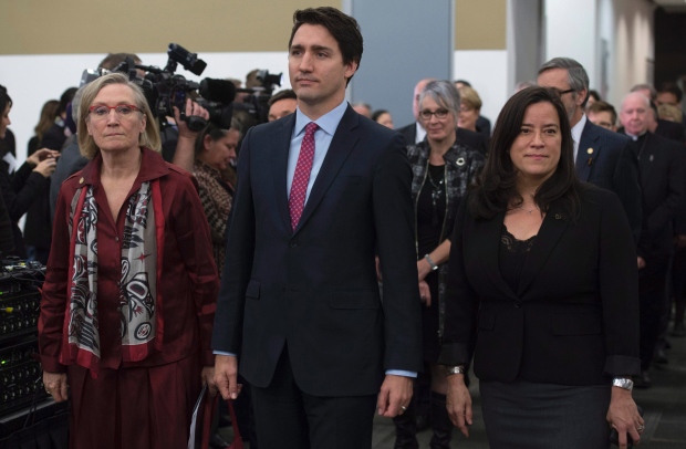 Trudeau takes part in the grand entrance with Indigenous and Northern Affairs Minister Carolyn Bennett, left, and Justice Minister Jody Wilson-Raybould at the Truth and Reconciliation commission event. (Adrian Wyld/Canadian Press)
