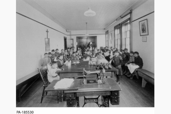 Mi’kmaq girls pose for a photo during a sewing class at Shubenacadie Indian Residential School in Nova Scotia in 1929.