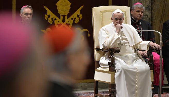 Pope Francis listens during a session with cardinals and bishops of the Vatican Curia last year when they met to exchange Christmas greetings. (THE ASSOCIATED PRESS)