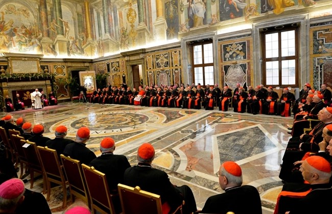 In this Dec. 22, 2014 file photo, Pope Francis, background left, delivers his message during his meeting with Cardinals and Bishops of the Vatican Curia on the occasion of the exchange of Christmas greetings in the Clementine hall at the Vatican. Pope Francis entered his 80th year on Thursday, Dec. 17, 2015 amid hopes among his critics that it will be his last, at least as pope. (AP Photo/Andreas Solaro, Pool)