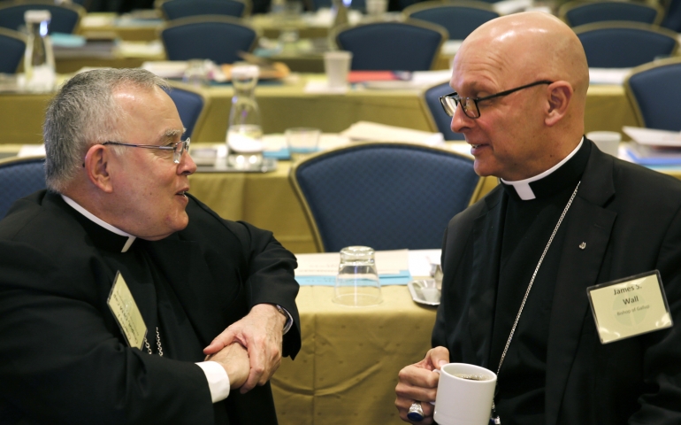 Archbishop Charles J. Chaput of Philadelphia and Bishop James S. Wall of Gallup, N.M., chat during a break at the 2015 fall general assembly of the U.S. Conference of Catholic Bishops in Baltimore Nov. 17. (CNS/Bob Roller)