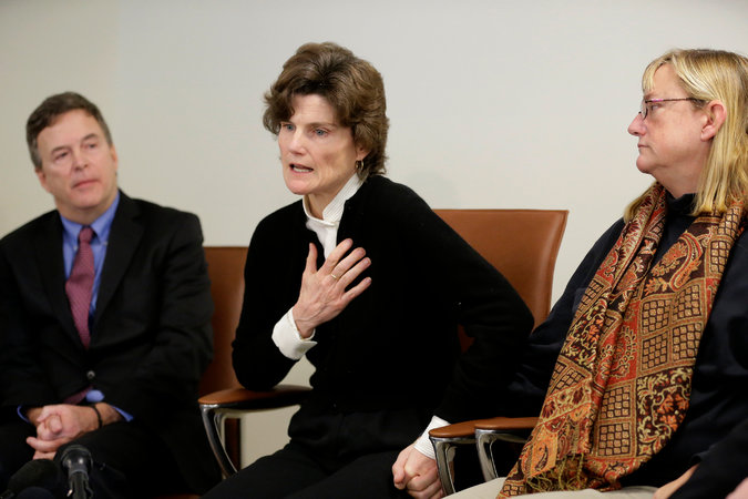 Anne Scott, center, a 1980 graduate of the school whose reports of her rape by the school’s now deceased athletic trainer began the investigations.