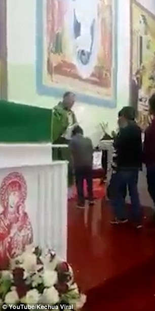 The unnamed priest grabs each child by the hair as they parade past him at the altar and pulls their head from side to side