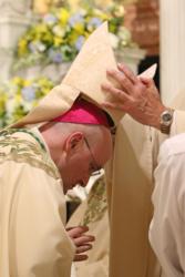 Bishop Nicholas DiMarzio of Brooklyn, N.Y., places a miter on Auxiliary Bishop James Massa during his 2015 episcopal ordination in Brooklyn. Although the number is not high, it is no longer "exceptional" to have priests turn down an appointment as bishop, said Canadian Cardinal Marc Ouellet, prefect of the Congregation for Bishops. (CNS photo/Gregory A. Shemitz) See OUELLET-NEW-BISHOPS Feb. 2, 2016.