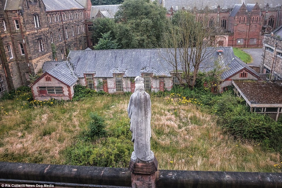 The statue on the roof seems to look down on St Joseph's Seminary, where the overgrown grass on some parts of the site is now as tall as the windows on the buildings