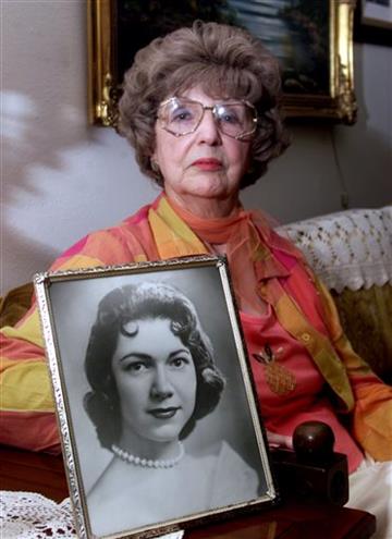 (Brad Doherty/The Dallas Morning News via AP). In this April 24, 2003, photo, Herlinda de la Vina holds a portrait of her niece, Irene Garza, the 25-year-old Texas schoolteacher and beauty queen in Edinburg, Texas, who was murdered in McAllen, Texas in...