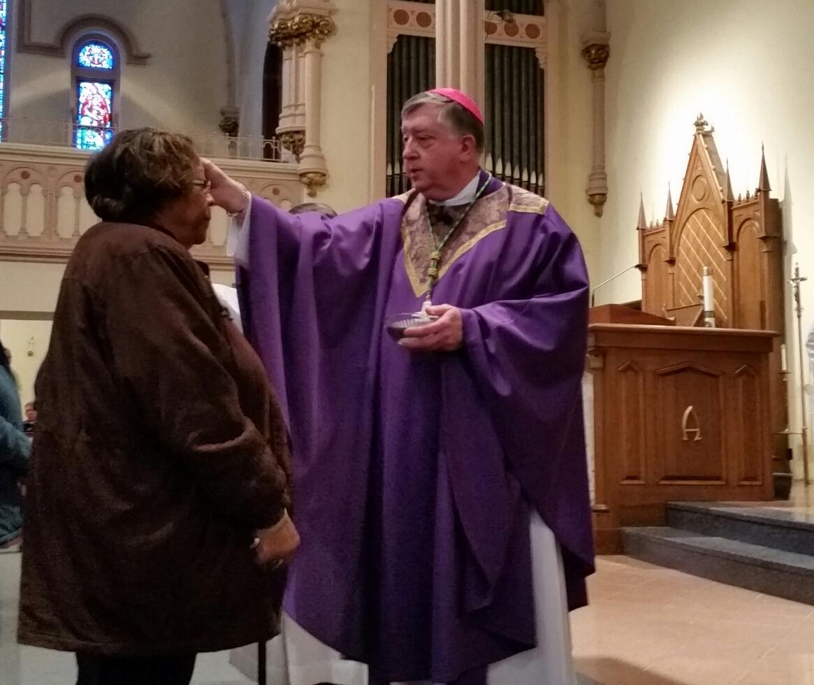 Springfield Bishop Mitchell Rozanski distributes ashes at St. Michael's Cathedral.