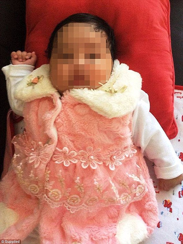 The sign directly targets the Australian government's decision to send baby Asha (pictured) back to an off-shore detention facility
