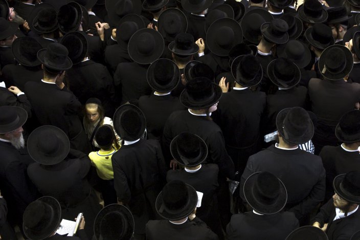 Ultra-Orthodox Jewish men mourn the death of Rabbi Eliezer Hager of Viznitch during his funeral in Haifa, Israel, on July 8, 2015.