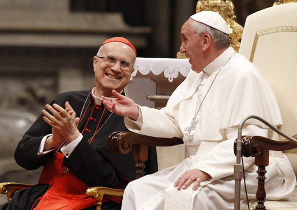 Cardinal Tarcisio Bertone, Vatican secretary of state, reacts as Pope Francis makes a comment during an audience with pilgrims from the Diocese of Bergamo, Italy, on June 3, 2013, in St. Peter’s Basilica at the Vatican. Photo by Paul Haring, courtesy of Catholic News Service