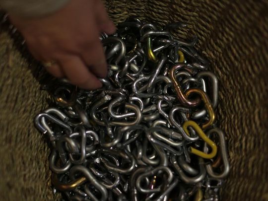 A woman takes a chain link, that represents all that is holding us back, chaining us down to fully receive healing from Jesus Christ, before a healing prayer service at Our Lady of Lourdes in De Pere on Wednesday, April 13, 2016. (Photo: Evan Siegle/USA TODAY NETWORK-Wisconsin)