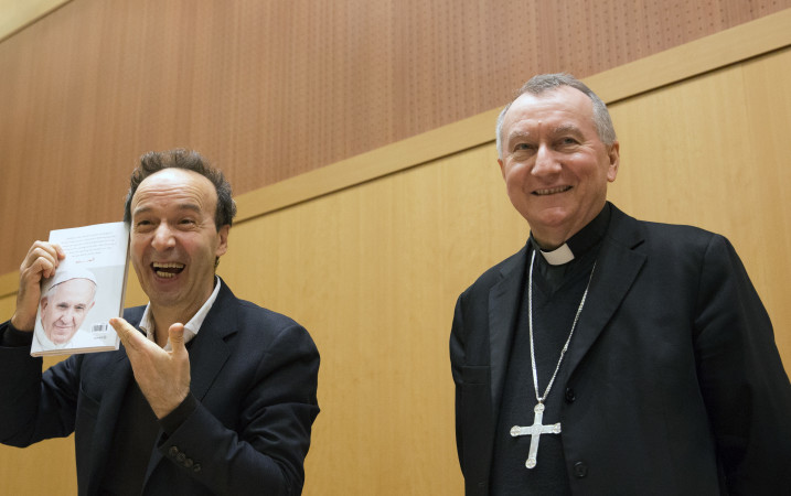 Italian actor Roberto Benigni, left, and Vatican Secretary of State Cardinal Piero Parolin during the official launch of Pope Francis’ book “The Name of God is Mercy” Tuesday, Jan. 12, 2016. Parolin is one of seven cases during his first three years in which Pope Francis has replaced a senior Vatican official named by Pope Benedict XVI. (AP Photo/Alessandra Tarantino)