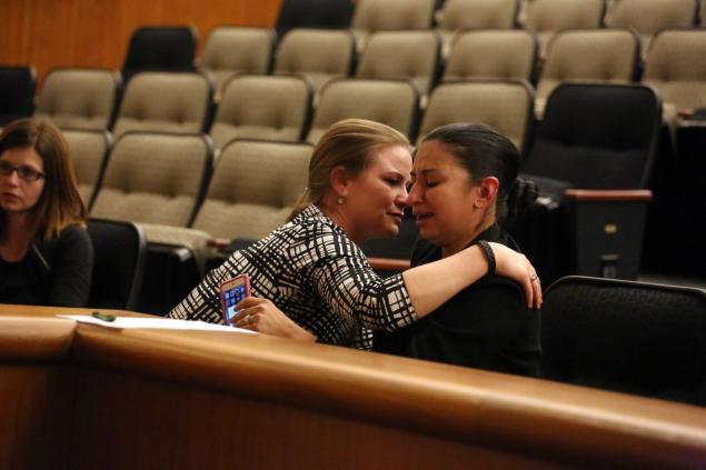 Ana Wagner (r.) breaks into tears as she tells her story of childhood sexual abuse and is comforted by child sex abuse survivor and speed skater Bridie Farrell.