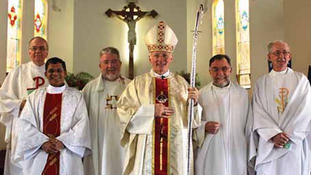 Bishop Les Tomlinson (fourth from left) with Father Joe Doyle (far right), photographed more than five years after the Melbourne Response ordered Fr Doyle to stop acting as a priest. Photo: supplied