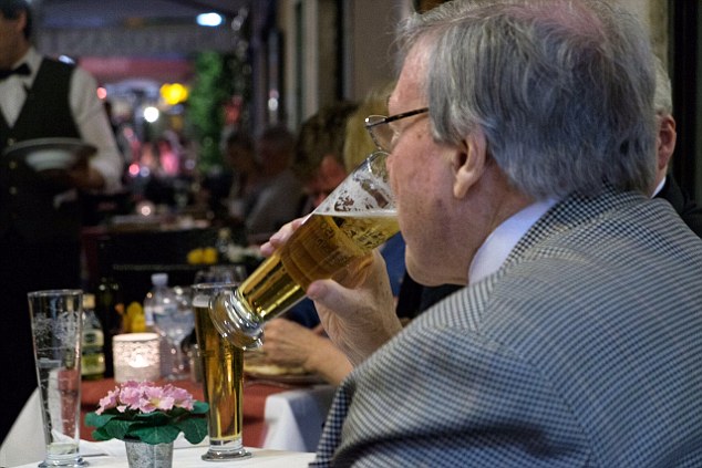 Australia's most senior Catholic, Cardinal Pell has been pictured strolling through a piazza in Rome with a colleague before they sit down at a restaurant to enjoy a beer