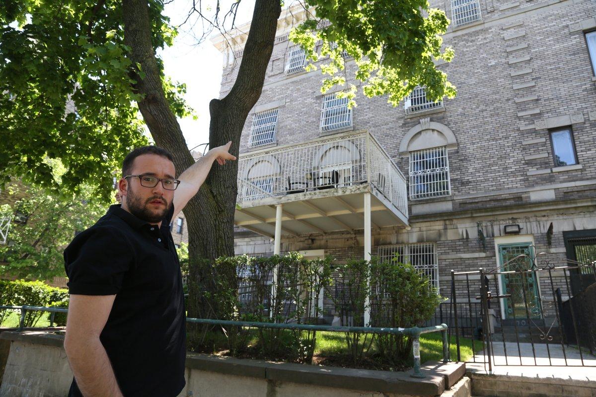 Chaim Levin points to the bedroom window of the house on Eastern Parkway where he was abused as a child. (JEFFERSON SIEGEL/NEW YORK DAILY NEWS)