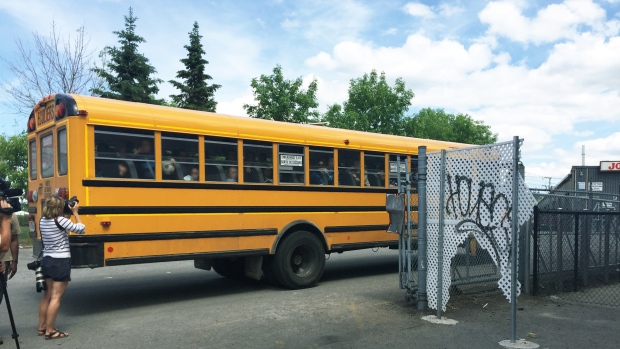 A school bus pulls away from a Hasidic school in Petite-Patrie, suspected of operating without an Education Ministry permit. Youth protection officials raided the premises Wednesday. (Ainslie MacLellan/CBC)