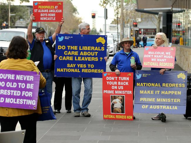 Protesters hold signs outside Newcastle Court House. Picture: Peter Lorimer
