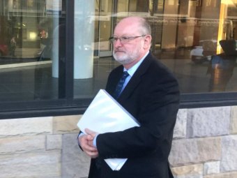 PHOTO: Former Newcastle diocesan registrar Peter Mitchell leaves the royal commission's public hearings. (ABC News: David Marchese)