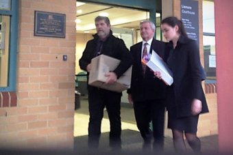 PHOTO: Father John Casey (centre) pleaded not guilty to all charges. (ABC: Joanne Shoebridge.)