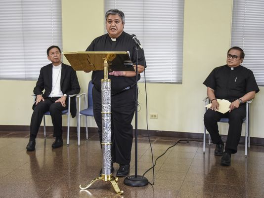 Archdiocese of Agana Delegate to the Apostolic Administrator Father Jeff San Nicolas, standing, is flanked by Archbishop Savio Hon Tai Fai, left, Archdiocese of Agana apostolic administrator and Monsignor James Benavente, during a press conference at the Dulce Nombre de Maria Cathedral-Basilica in Hagatna on Monday, Oct. 3. San Nicolas announced, that as of Oct. 1, Benavente has been appointed to serve as Delegate of the Apostolic Administrator for Church Patrimony.