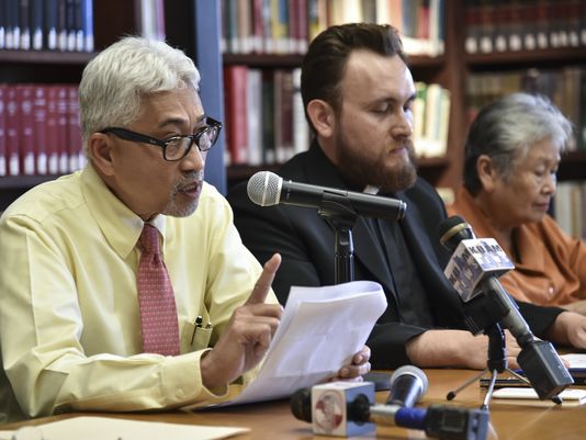 Dr. Ricardo Eusebio of theRedemptorisMater Seminary board of directors, left, defends the seminary at a press conference in Yona on Oct. 13. After refuting allegations of wrongdoing from the Catholic Archdiocese of Agana, Eusebio said, "The Neocatechumenal Way will always be. God will pave the way,"