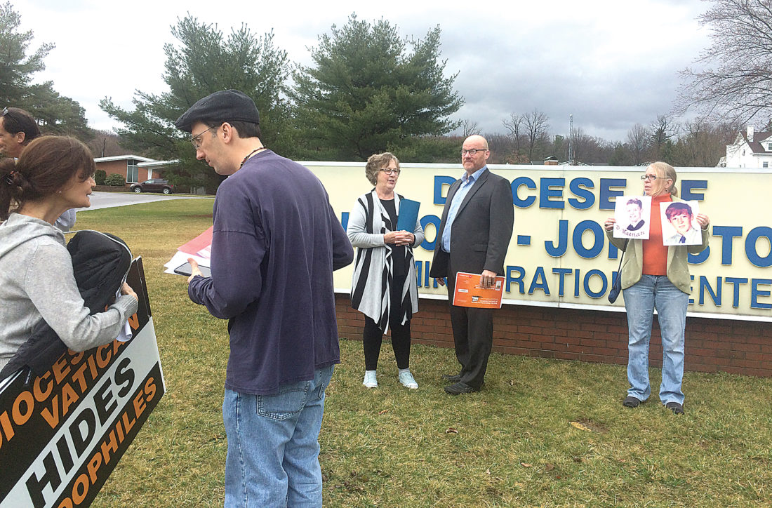 About 10 members of the Survivors Network of those Abused by Priests gathered Wednesday for a demonstration in front of the Altoona-Johnstown Diocese administration building on Logan Boulevard. Survivors of sexual abuse at the hands of local Roman Catholic clergy don’t believe much has changed since last year’s grand jury report. Mirror photo by Russ O’Reilly