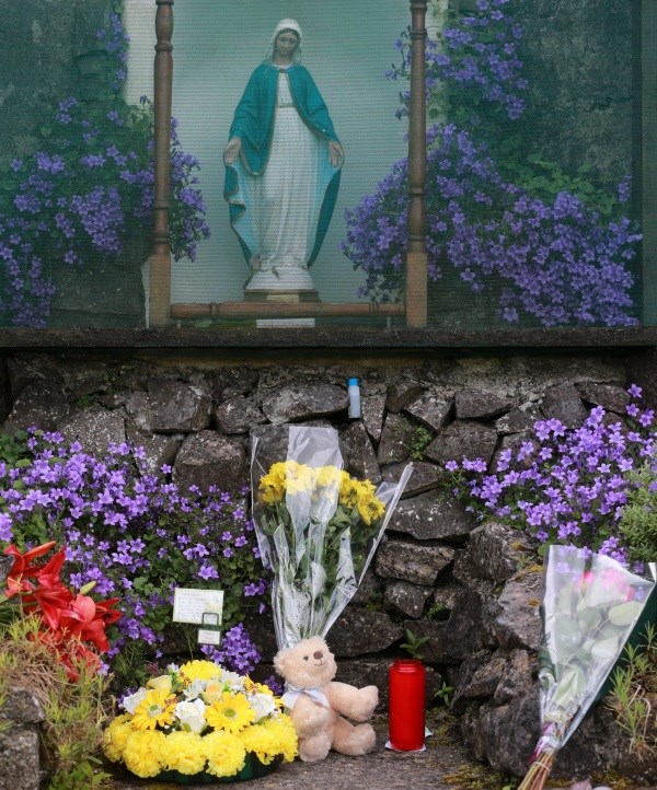 Flowers and tributes left in 2014 at the site of the unmarked mass grave containing the remains of nearly 800 infants who died at the Bon Secours mother-and-baby home in Tuam, Co Galway from 1925-1961.