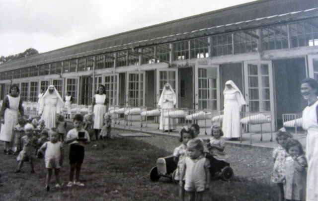 Children taking the area, supervised by nuns, at and Irish Mother and Baby Home.