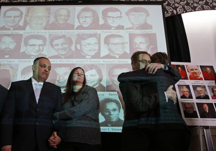 Carmen Severino, an abuse survivor, is embraced during a news conference that heralded the release of thousands of documents from the Chicago Archdiocese on past cases of clergy sexual abuse in January 2014. (CNS photo/Jim Young, Reuters)