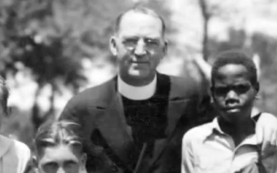 Father Flanagan photographed with some children at Boys Town.