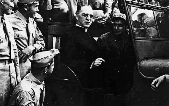 Father Flanagan surrounded by World War II troops.