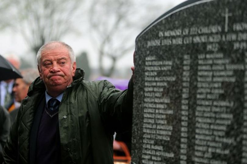 Chairman of the Bethany Survivors group Derek Leinster looks at the memorial to 222 children from the Bethany Mother and Child Home, at Mount Jerome Cemetery.