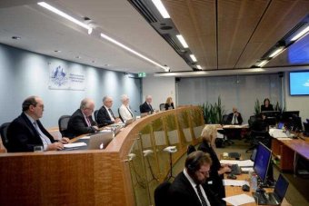 PHOTO: Commissioners listen to evidence during the public hearing in Sydney. (AAP: Jeremy Piper)