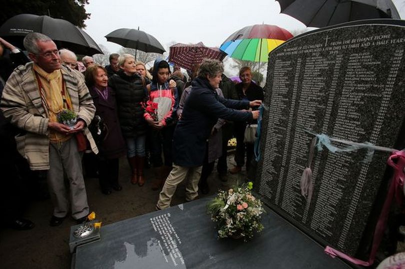 Lorraine Jackson, from Killenard, Laois, who spent nine months in the home shortly after her birth, cuts a ribbon to unveil the memorial to 222 children from the Bethany Mother and Child Home.