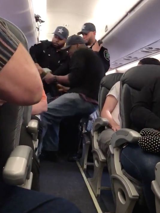 Screen shot from a video of a man being dragged off of a United Airlines' plane before it left Chicago and headed to Louisville.