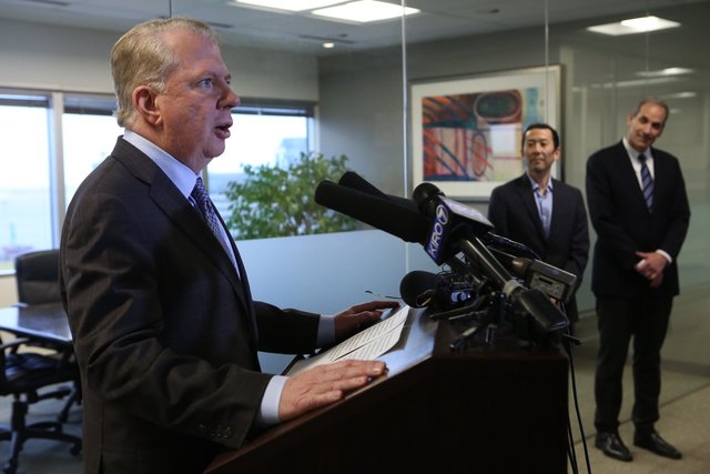 Seattle Mayor Ed Murray at a news conference in the law offices of his attorneys, April 7. At center is Murray’s husband Michael Shiosaki and at far right is his attorney Bob Sulkin. (Ellen M. Banner/The Seattle Times)