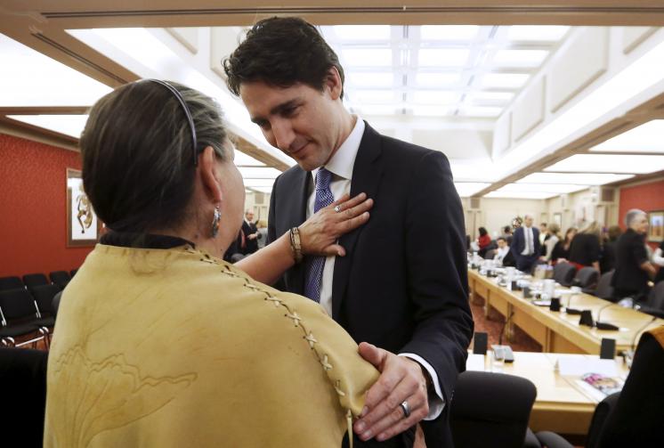 Prime Minister Justin Trudeau of Canada greets a woman upon the release of the Truth and Reconciliation Commission's final report in Ottawa in 2015. (CNS photo/Chris Wattie, Reuters)