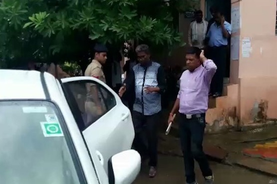Catholic Father Leo D'Souza (in the middle) is taken by police after he was accused of sexually abusing a school student. Local Christians suspect he was framed in the case to tarnish the image of church and the reputation of the school. (Photo supplied)