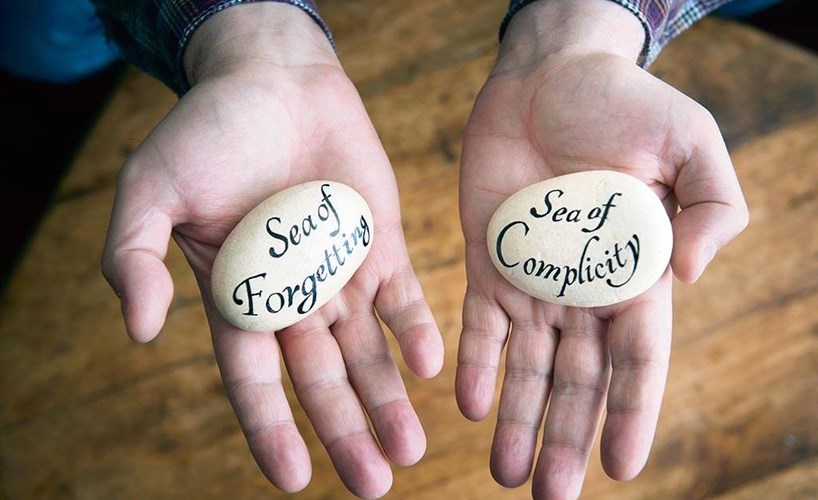 Hard message: Gilo holds two calligraphed stones which he made as a reflection upon his experience of trying to get the Church to listen to his story of abuse